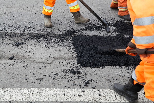 Workers Applying Asphalt